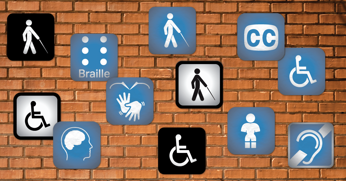 Uma parede de tijolinhos aparentes com várias placas azuis com os símbolos de acessibilidade, como o símbolo internacional do acesso, o símbolo de Braille, o símbolo de pessoa com deficiência visual, símbolo de legendas, símbolo de pessoa com deficiência auditiva, símbolo de pessoa com nanismo.